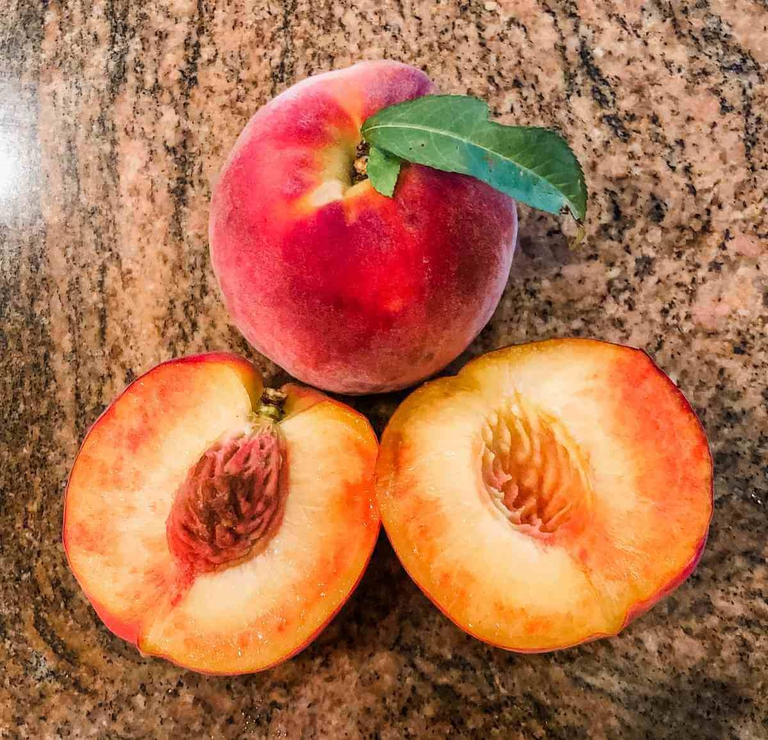 Beautiful shot of a freestone Bennett Peach cut in half. 